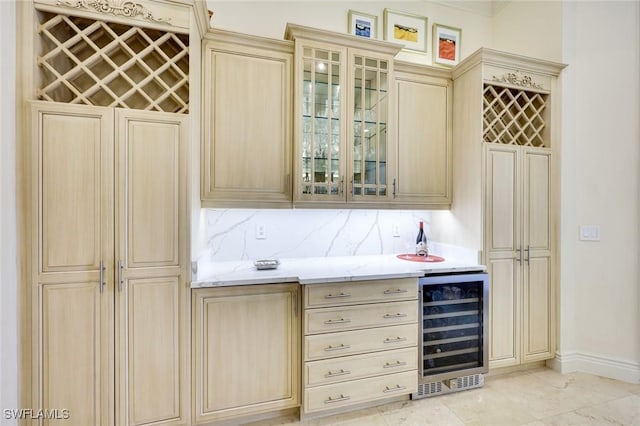 bar with beverage cooler, a dry bar, baseboards, and decorative backsplash