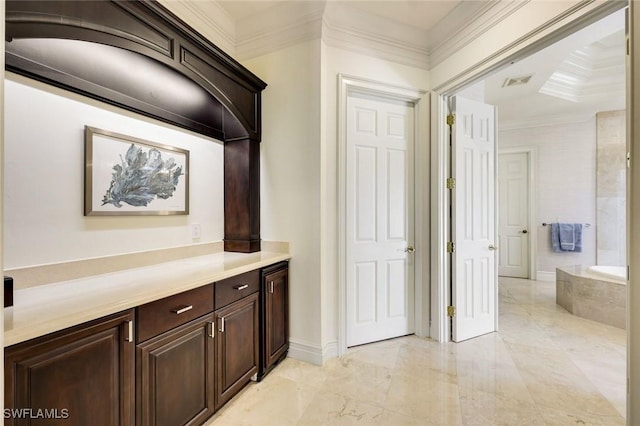 hallway featuring ornamental molding, marble finish floor, visible vents, and baseboards