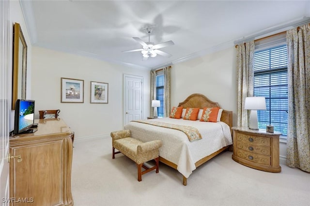 bedroom with crown molding, a closet, carpet flooring, ceiling fan, and baseboards