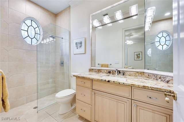 full bathroom featuring tile patterned floors, vanity, toilet, and a walk in shower