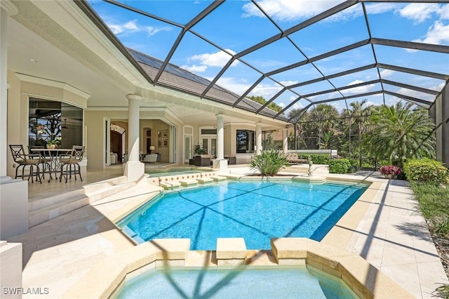 view of pool featuring a pool with connected hot tub and a patio