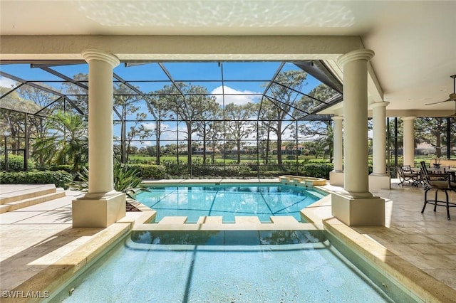 view of pool featuring ceiling fan, a patio area, a lanai, and a pool with connected hot tub