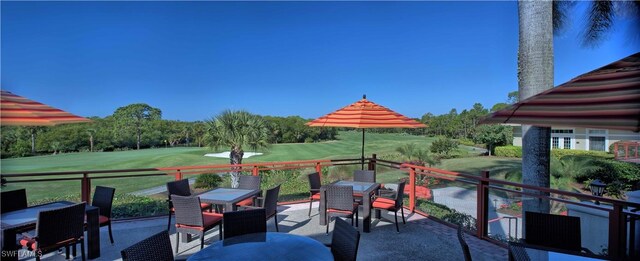 exterior space with outdoor dining space and golf course view