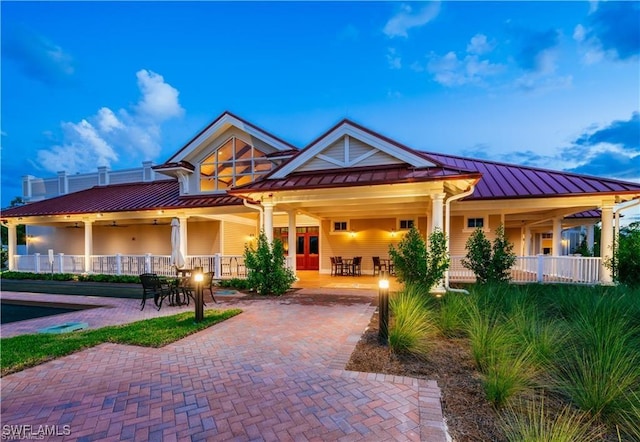 view of front of house featuring a standing seam roof, metal roof, and decorative driveway