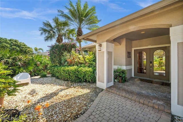 property entrance with french doors and stucco siding