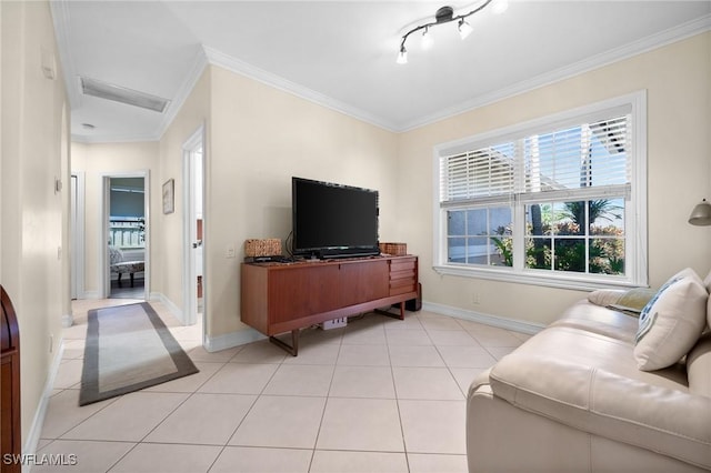 living room with light tile patterned floors, ornamental molding, and baseboards