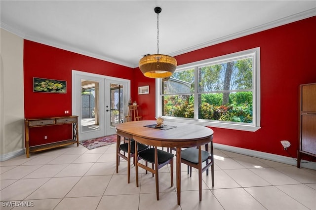 dining room featuring a wealth of natural light, baseboards, crown molding, and french doors