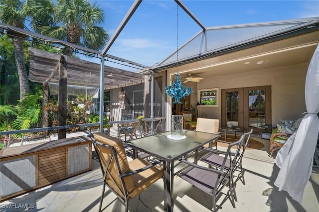 sunroom featuring vaulted ceiling, ceiling fan, and french doors