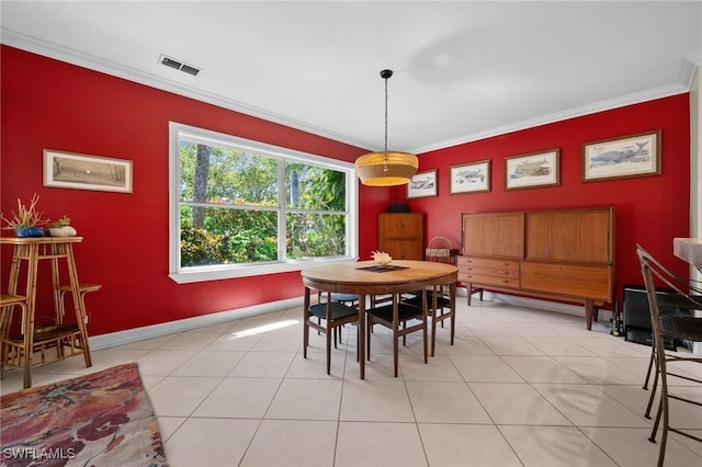 dining area featuring baseboards, light tile patterned floors, visible vents, and crown molding