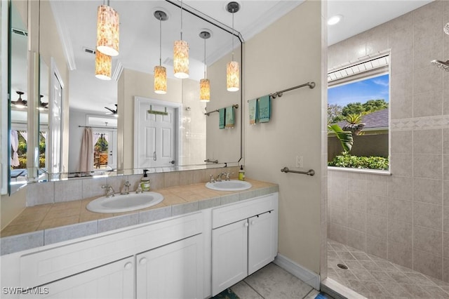 bathroom with double vanity, a sink, visible vents, and crown molding