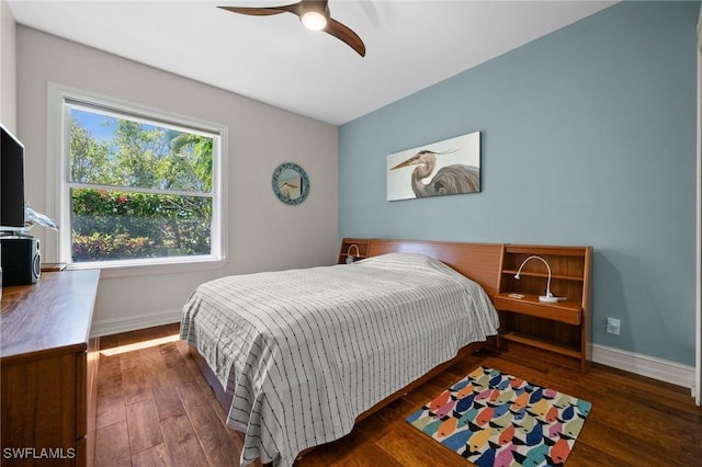 bedroom featuring a ceiling fan, baseboards, and wood finished floors