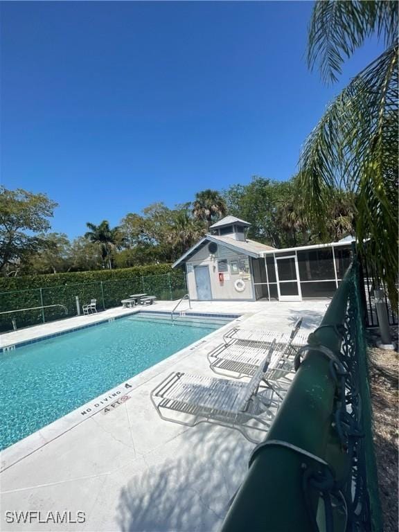 community pool featuring a patio area and fence