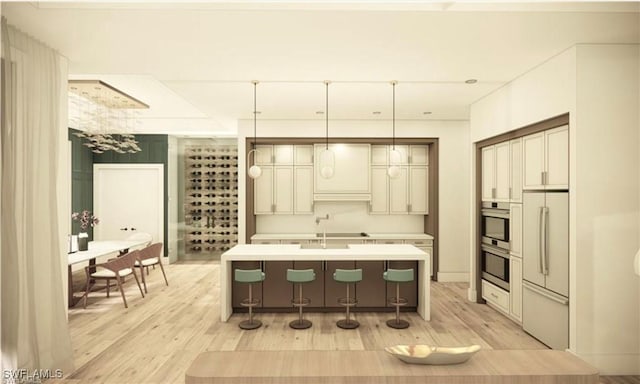 kitchen featuring light countertops, an island with sink, light wood-type flooring, and white fridge