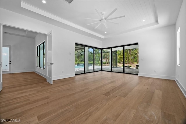 3233 64th St SW, Naples, FL 34105 - spare room featuring a ceiling fan, a tray ceiling, light wood-style flooring, and recessed lighting