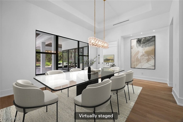 3233 64th St SW, Naples, FL 34105 - dining space featuring wood finished floors and a tray ceiling