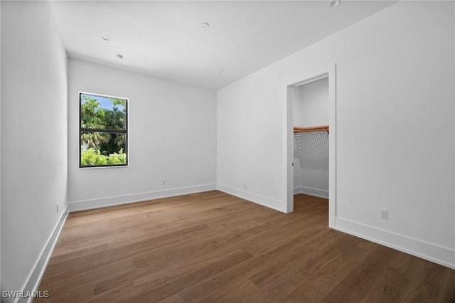 3233 64th St SW, Naples, FL 34105 - unfurnished bedroom with wood finished floors and a spacious closet