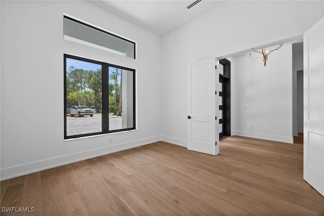 3233 64th St SW, Naples, FL 34105 - unfurnished room with light wood-type flooring and a chandelier