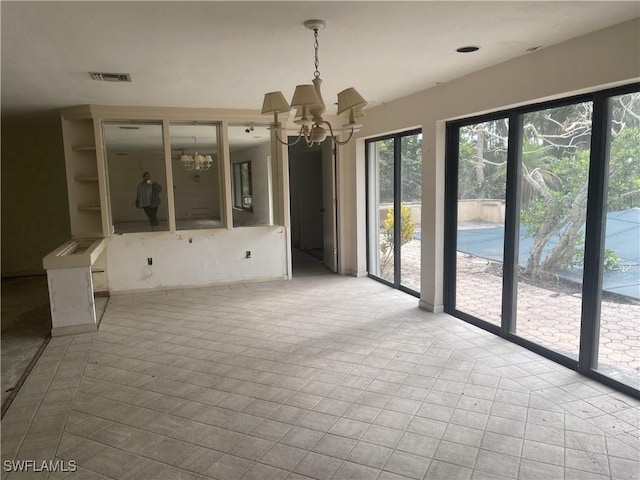 545 Boulder Dr, Sanibel, FL 33957 - empty room featuring a chandelier and tile patterned flooring
