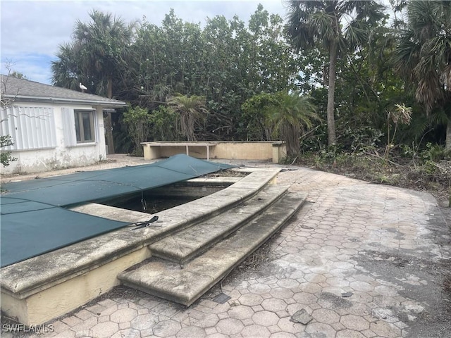 545 Boulder Dr, Sanibel, FL 33957 - view of swimming pool featuring a covered pool and a patio