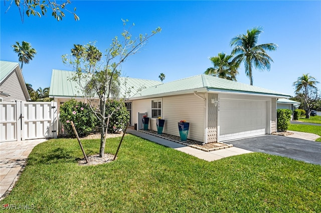 single story home with a gate, fence, metal roof, a front yard, and a garage