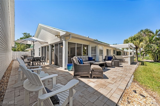 view of patio featuring outdoor dining space, outdoor lounge area, a sunroom, and fence