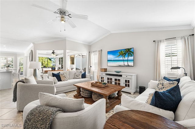 living room featuring vaulted ceiling, plenty of natural light, a ceiling fan, and ornamental molding