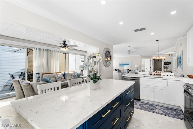 kitchen featuring ceiling fan with notable chandelier, visible vents, open floor plan, and ornamental molding