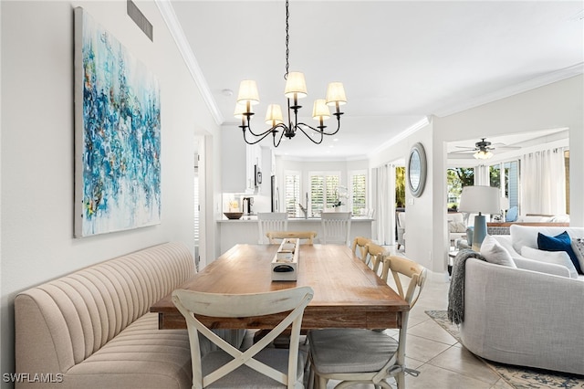 dining room featuring light tile patterned floors, ceiling fan with notable chandelier, visible vents, and ornamental molding