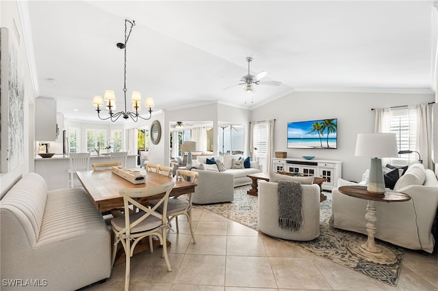 living area with light tile patterned floors, lofted ceiling, plenty of natural light, crown molding, and ceiling fan with notable chandelier