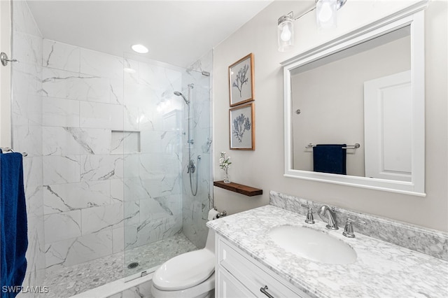 full bathroom featuring a marble finish shower, toilet, and vanity