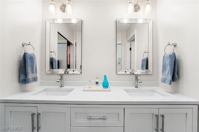 full bath with a sink and double vanity