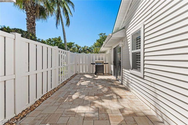 view of patio / terrace with grilling area and a fenced backyard