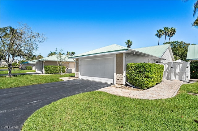 view of front of house featuring metal roof, central air condition unit, and a front lawn