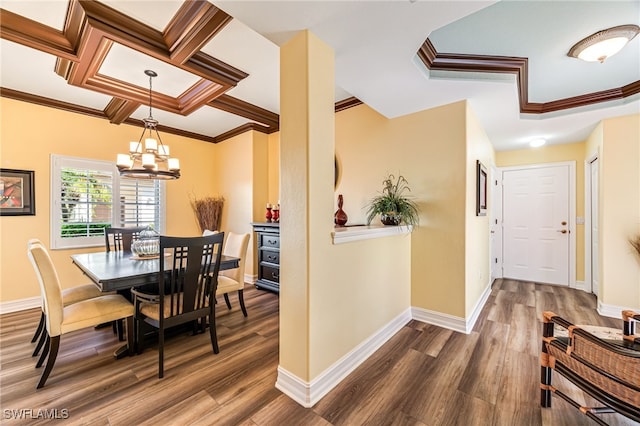 dining space featuring an inviting chandelier, ornamental molding, and wood finished floors