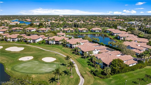 aerial view with view of golf course, a water view, and a residential view