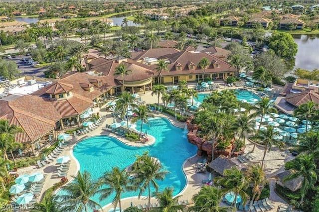 view of pool with a water view and a residential view