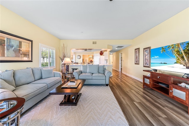 living area featuring baseboards and wood finished floors