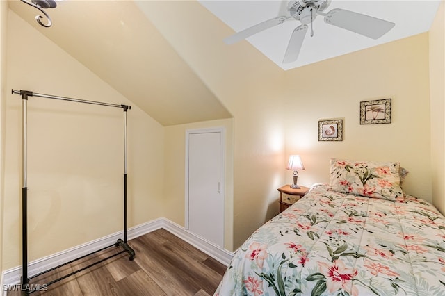 bedroom with a ceiling fan, vaulted ceiling, baseboards, and wood finished floors