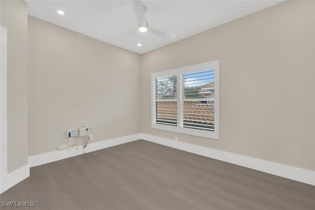 empty room featuring dark wood finished floors, recessed lighting, a ceiling fan, and baseboards