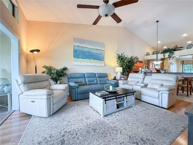 living room featuring high vaulted ceiling, a ceiling fan, and wood finished floors