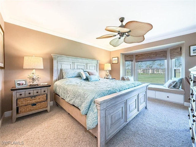 bedroom with light carpet, crown molding, and baseboards