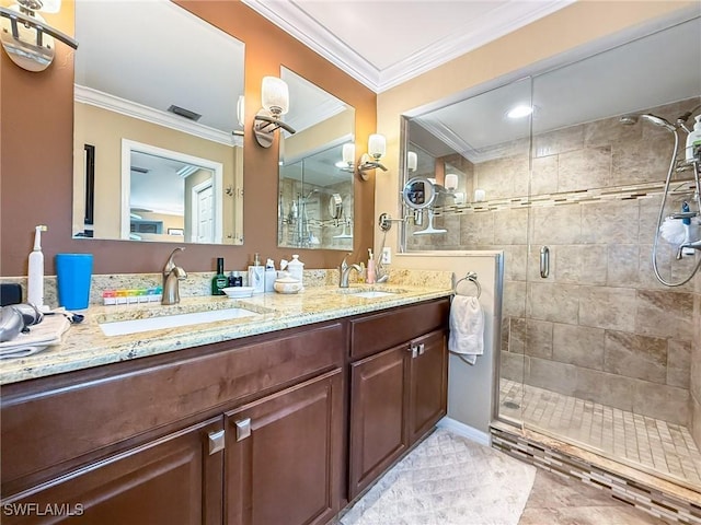 full bath with double vanity, a stall shower, crown molding, and a sink