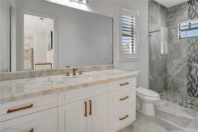 bathroom featuring vanity, a shower stall, toilet, and a healthy amount of sunlight