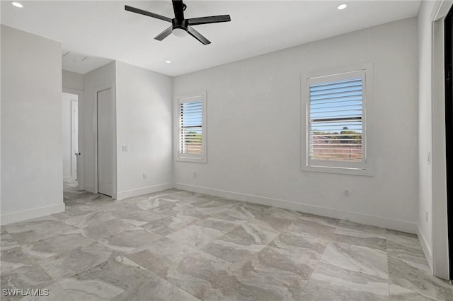 empty room with recessed lighting, baseboards, marble finish floor, and ceiling fan