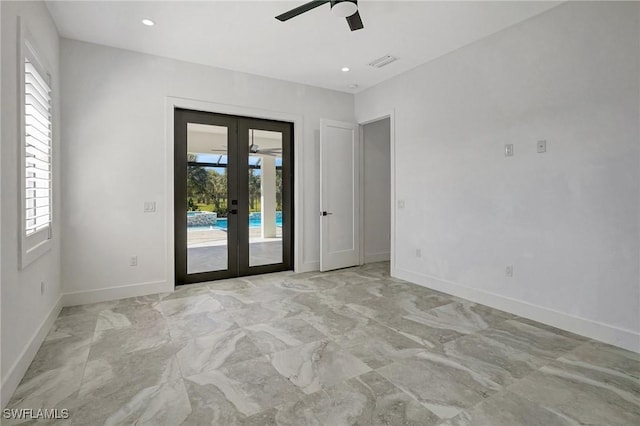 spare room featuring visible vents, baseboards, recessed lighting, french doors, and marble finish floor