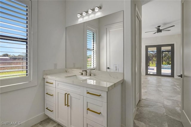 bathroom with a wealth of natural light, french doors, and a ceiling fan