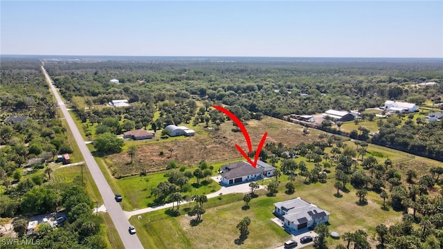 bird's eye view featuring a wooded view