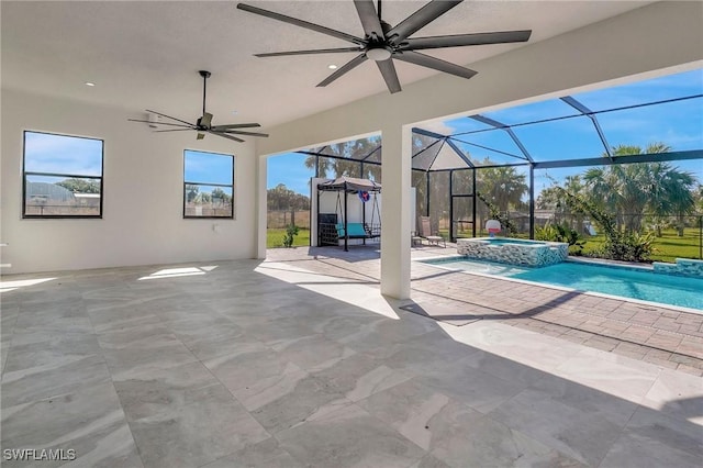 view of pool featuring a patio, a lanai, a ceiling fan, and a pool with connected hot tub