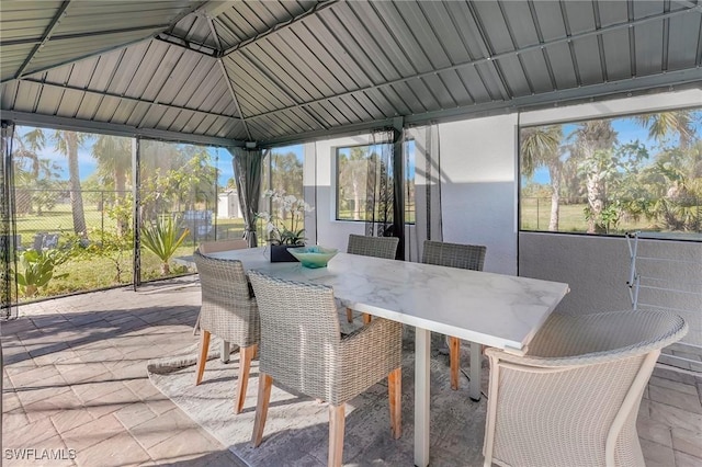 sunroom featuring vaulted ceiling