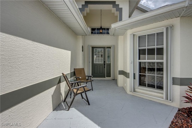 view of exterior entry featuring stucco siding